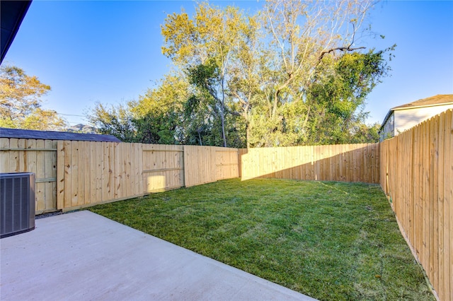 view of yard featuring a fenced backyard and central AC unit