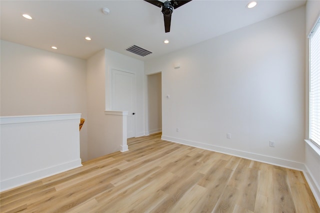 empty room with baseboards, visible vents, a ceiling fan, light wood-style floors, and recessed lighting