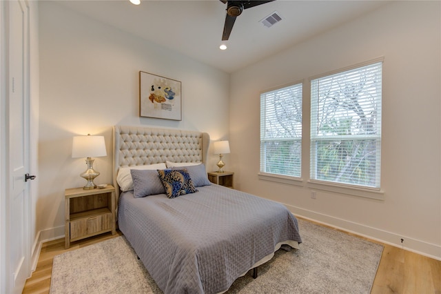 bedroom featuring recessed lighting, wood finished floors, visible vents, and baseboards