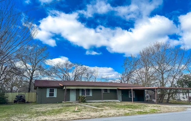 ranch-style home with a carport and a front lawn