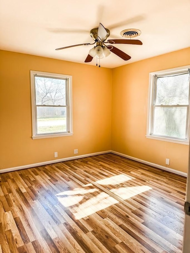 spare room featuring ceiling fan and light hardwood / wood-style flooring