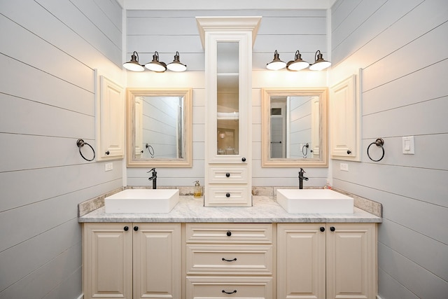 28600 Equestrian Dr, Waller, TX 77484 - bathroom with a sink, wooden walls, and double vanity