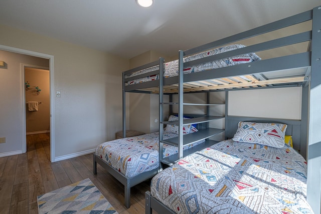 bedroom featuring baseboards and wood finished floors