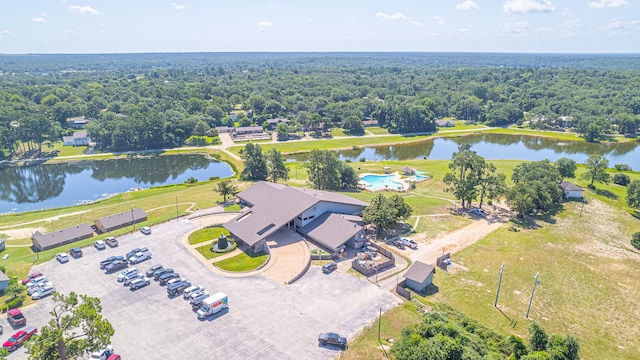 aerial view featuring a forest view and a water view