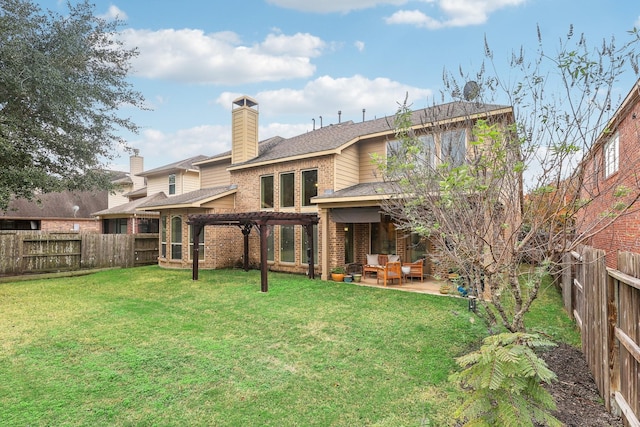 rear view of house with a yard, a pergola, and a patio