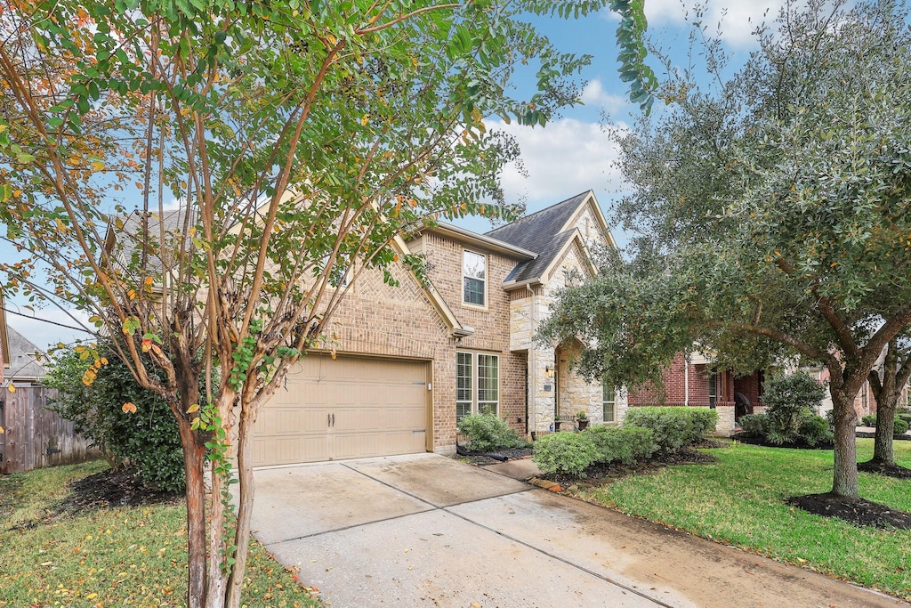 view of front of house featuring a garage and a front lawn