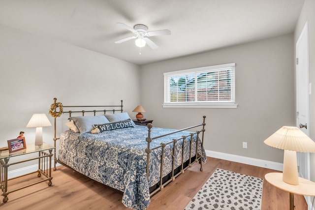 bedroom with ceiling fan and wood-type flooring