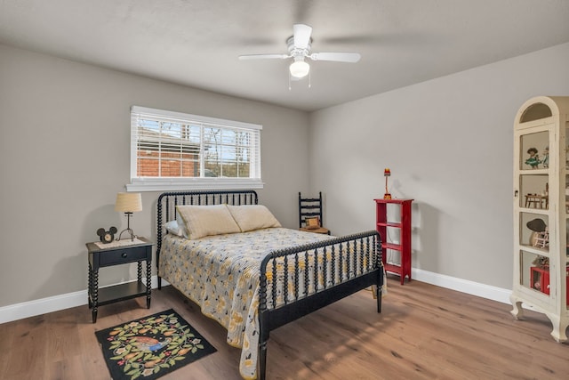 bedroom with hardwood / wood-style flooring and ceiling fan