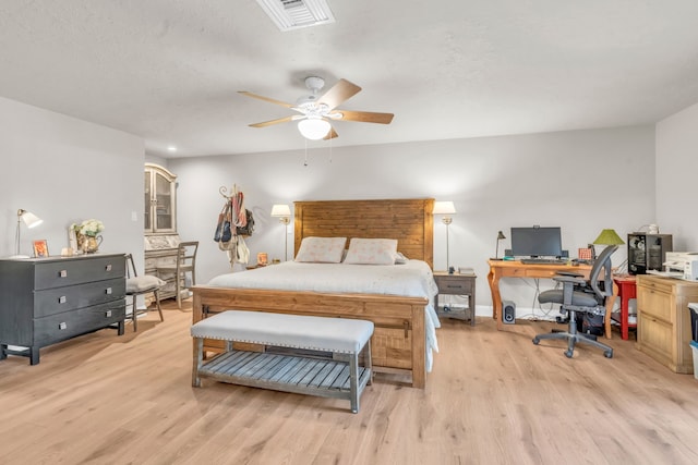 bedroom with light hardwood / wood-style floors and ceiling fan