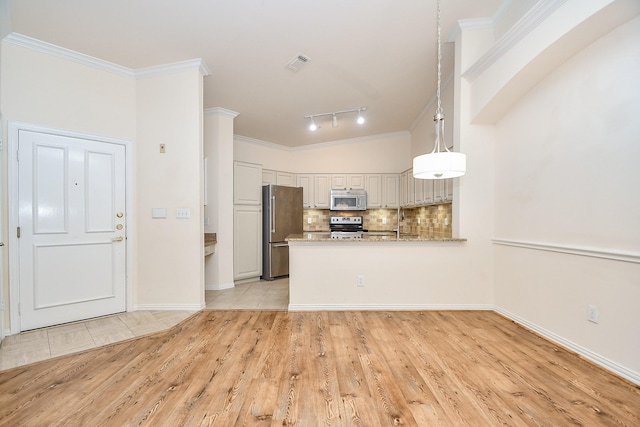 kitchen with ornamental molding, stainless steel appliances, kitchen peninsula, and hanging light fixtures