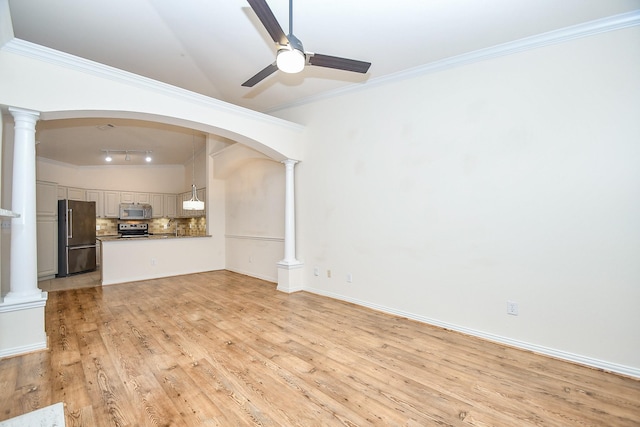 unfurnished living room with rail lighting, a ceiling fan, ornamental molding, light wood-style floors, and decorative columns
