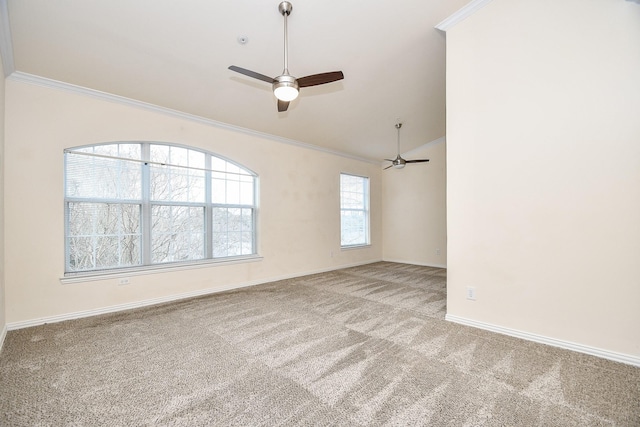 carpeted empty room with a ceiling fan, baseboards, and crown molding