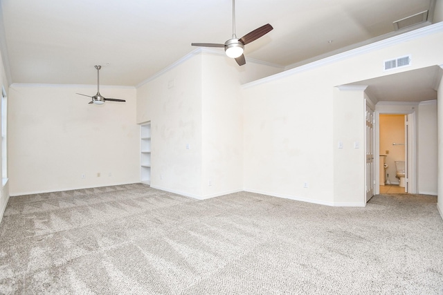 unfurnished room with ceiling fan, ornamental molding, carpet flooring, and visible vents