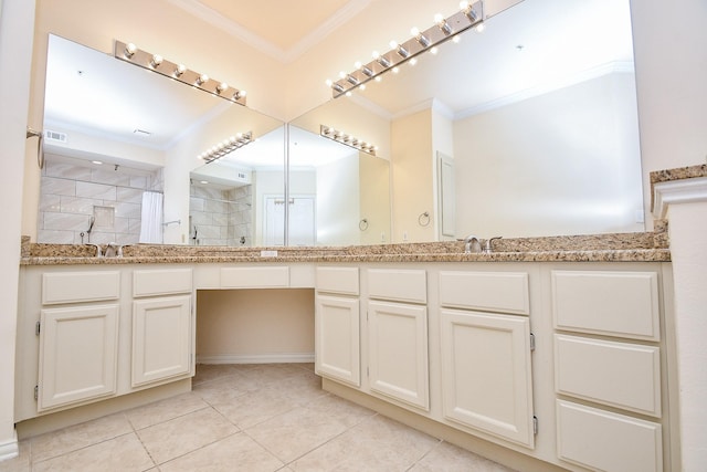 bathroom featuring tile patterned flooring, crown molding, a tile shower, and vanity