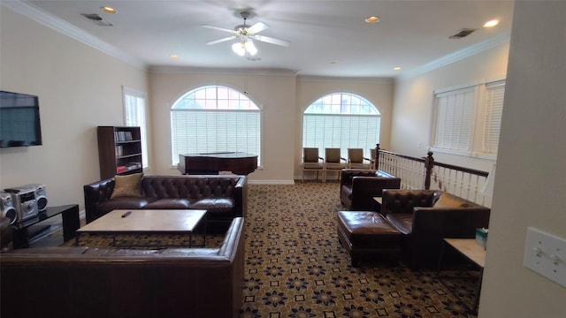 living room featuring ceiling fan, ornamental molding, and carpet