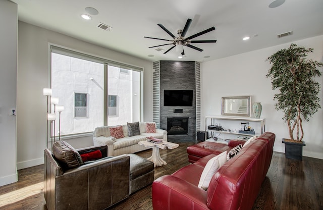 living area with dark wood-style floors, a fireplace, and visible vents