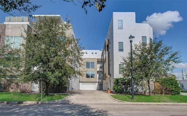 view of property featuring driveway and an attached garage