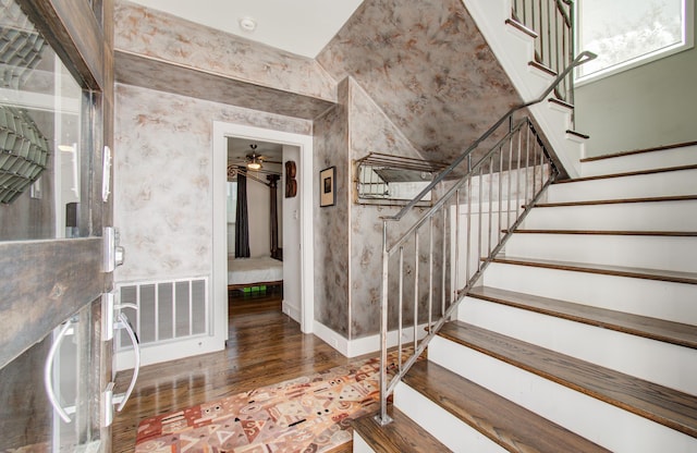 stairs featuring baseboards, visible vents, and wood finished floors