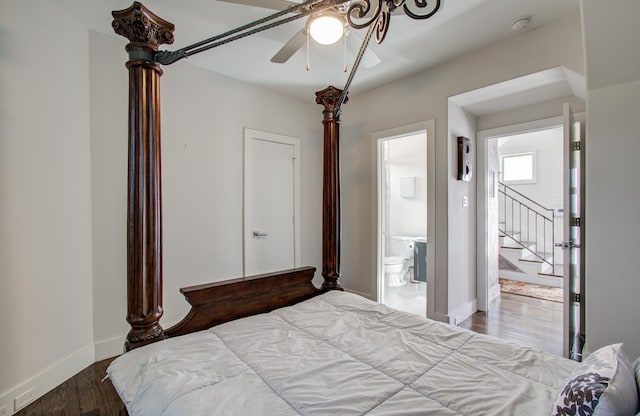 bedroom with ensuite bath, baseboards, and wood finished floors