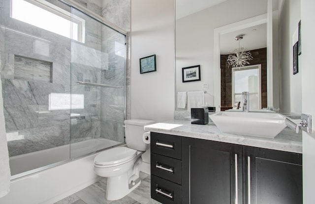 bathroom featuring enclosed tub / shower combo, marble finish floor, toilet, and vanity