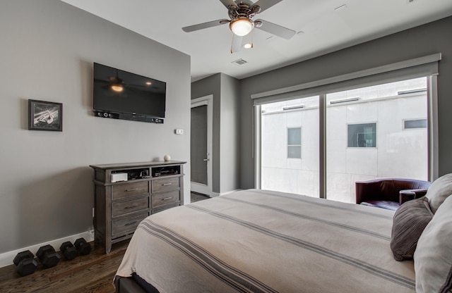 bedroom with dark wood-type flooring, visible vents, baseboards, and a ceiling fan