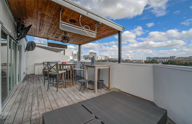 deck featuring outdoor dry bar and a city view