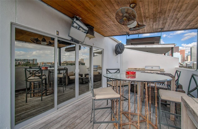 wooden deck featuring ceiling fan and outdoor dining space