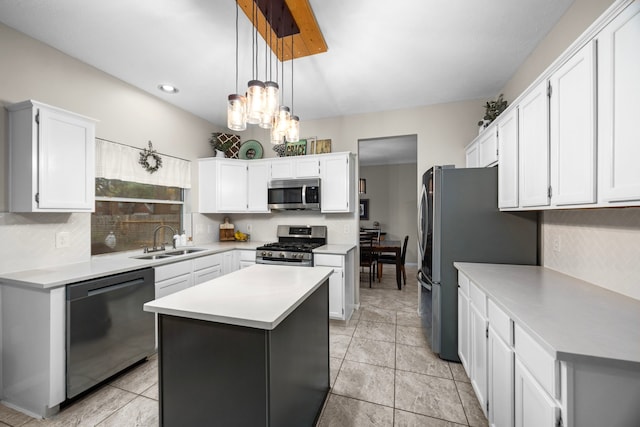 kitchen featuring sink, white cabinetry, decorative light fixtures, a center island, and appliances with stainless steel finishes