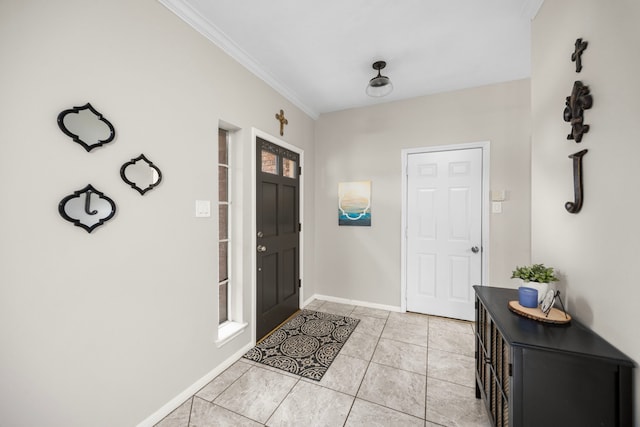 entrance foyer with ornamental molding and light tile patterned floors