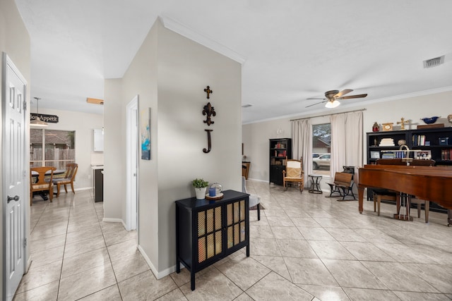 hallway featuring light tile patterned floors and crown molding