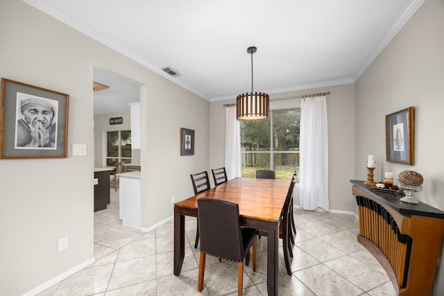 dining space featuring light tile patterned flooring and ornamental molding