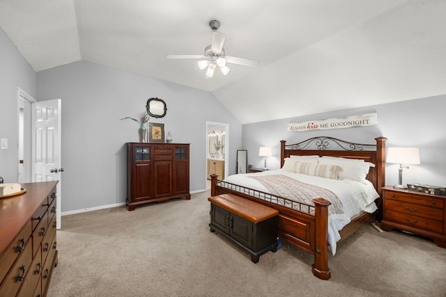 bedroom featuring ceiling fan, light colored carpet, lofted ceiling, and ensuite bathroom