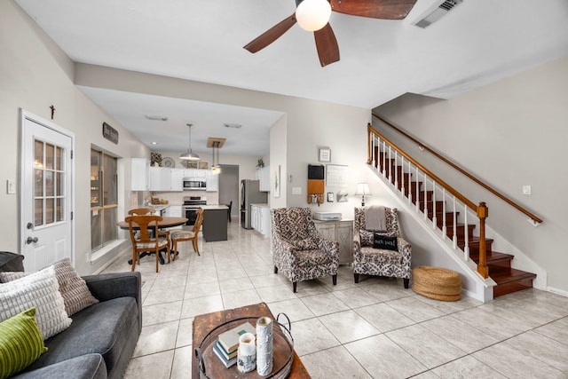 tiled living room with ceiling fan