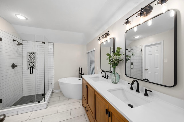 bathroom with vanity, tile patterned flooring, and plus walk in shower