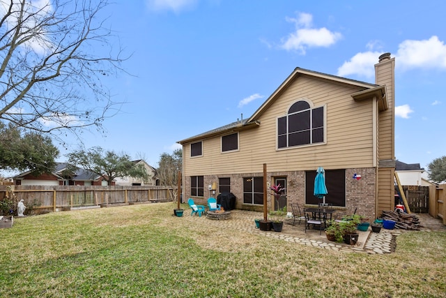 back of house featuring a lawn and a patio