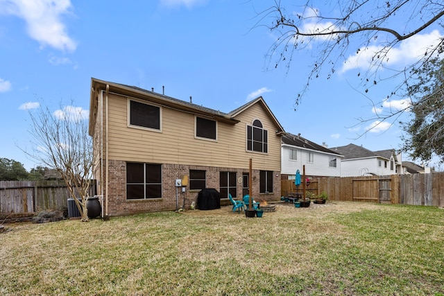 rear view of house with a yard and cooling unit