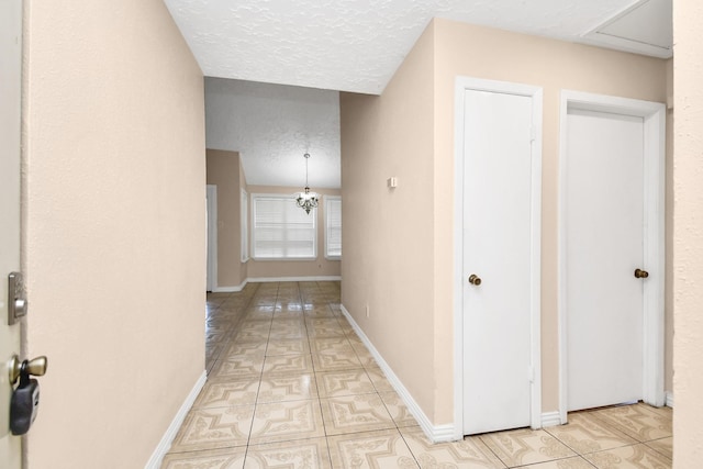 hallway with a textured ceiling