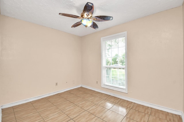 spare room featuring ceiling fan and a textured ceiling