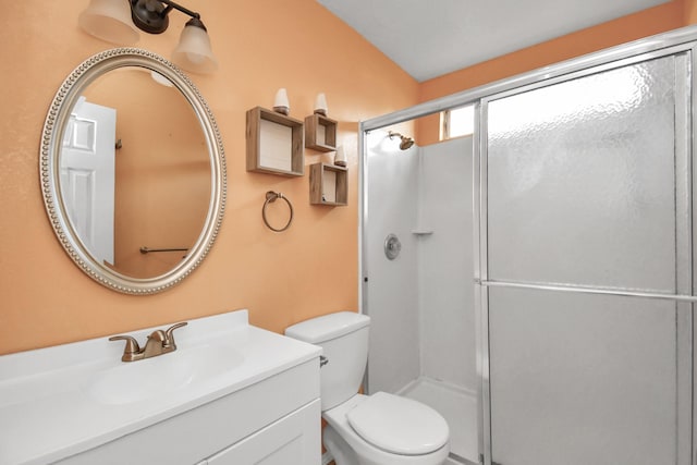 bathroom with vanity, toilet, and an enclosed shower