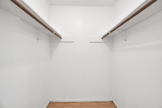 walk in closet featuring hardwood / wood-style floors