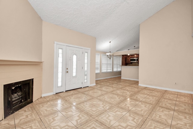 entryway featuring a notable chandelier, vaulted ceiling, and a textured ceiling