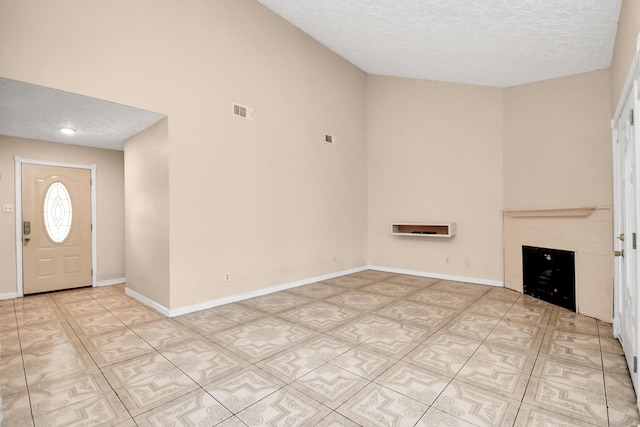 entrance foyer featuring a textured ceiling and a high ceiling