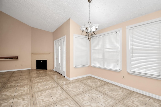 unfurnished dining area with a chandelier, vaulted ceiling, and a textured ceiling