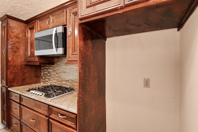 kitchen featuring stainless steel appliances and backsplash