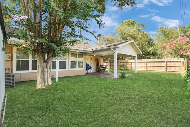 rear view of property featuring a yard and a patio