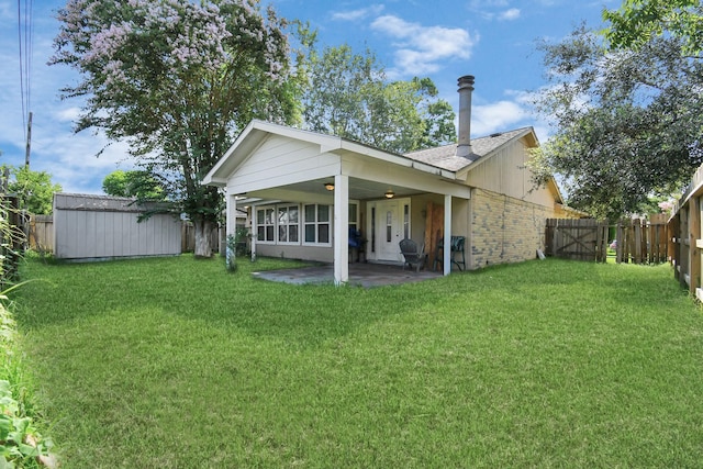 back of property featuring a patio, a shed, and a lawn