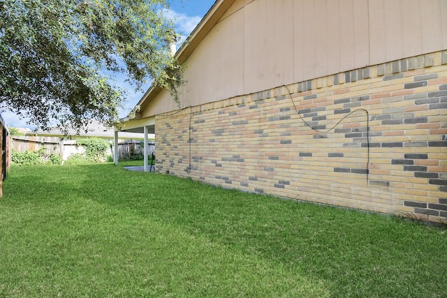 view of side of home featuring a yard