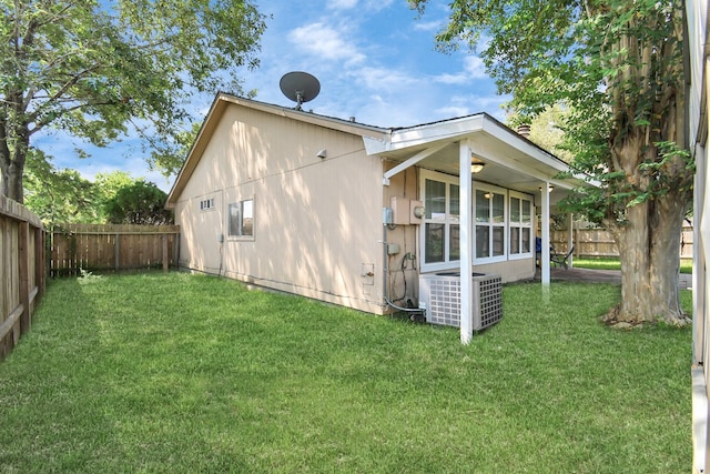 view of home's exterior featuring central air condition unit and a lawn