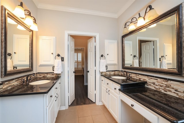 bathroom featuring ornamental molding, vanity, tile patterned floors, and decorative backsplash