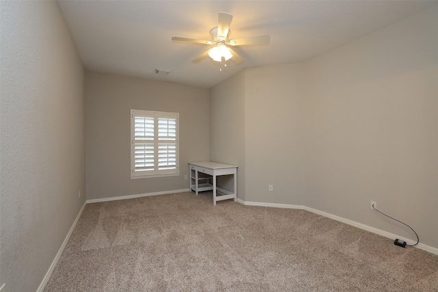 carpeted spare room featuring ceiling fan